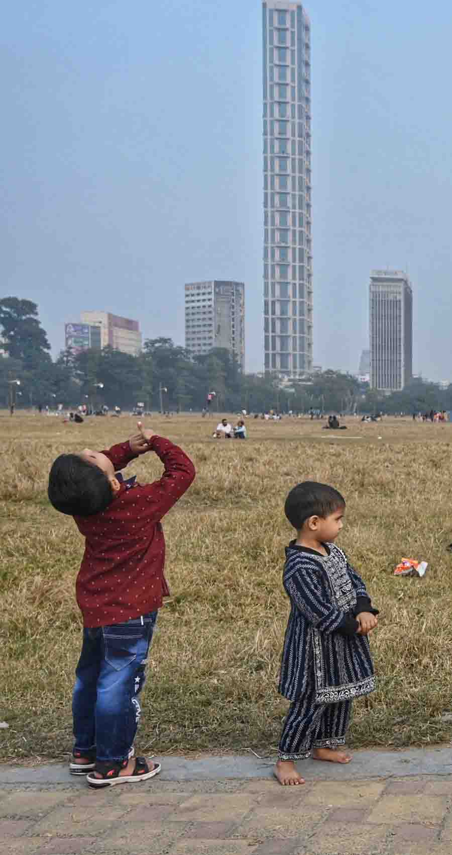 The ‘42’ skyscraper on Jawaharlal Nehru Road seems to amuse a couple of infants on the Maidan on Saturday afternoon