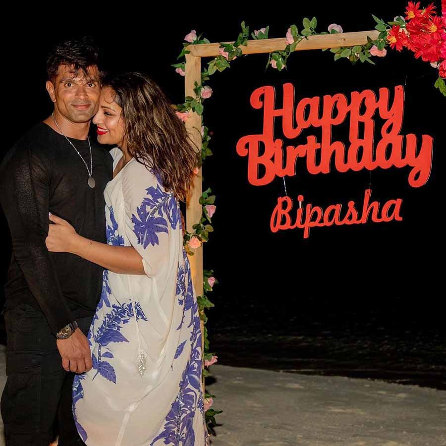 The Dhoom 2 actress embraced Karan against a wooden frame adorned with flowers and carrying a ‘Happy Birthday Bipasha’ text.   