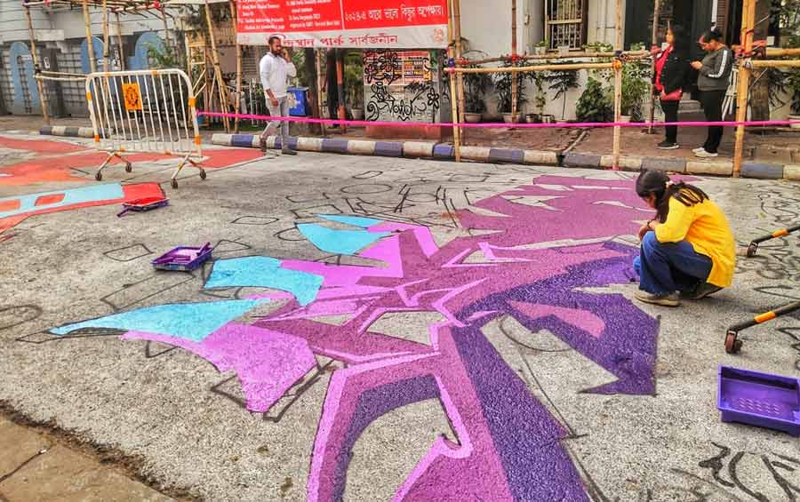 An artist busy making graffiti on the streets of Hindustan Park on Tuesday afternoon  