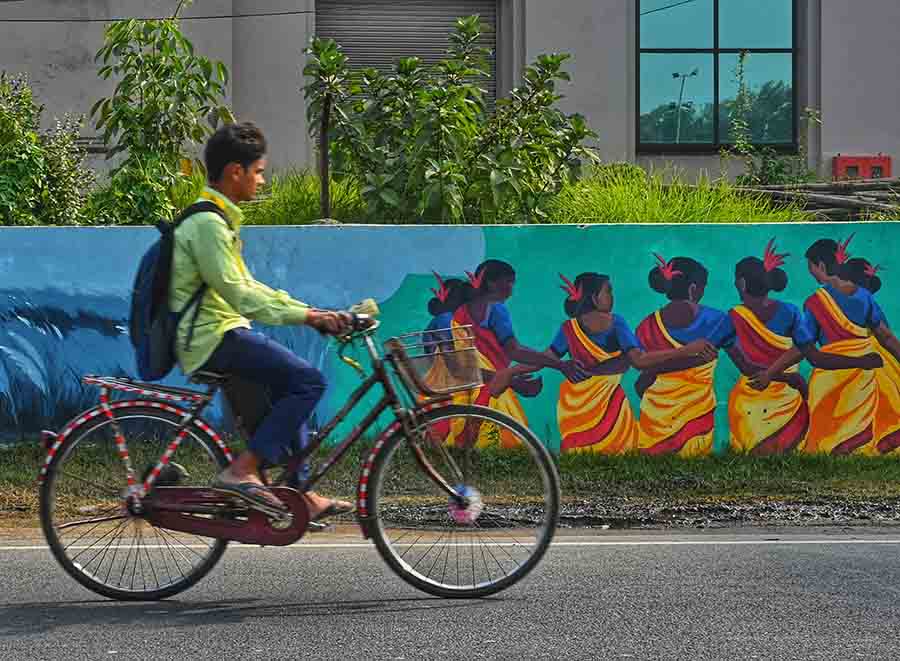 A colourful graffiti of tribal dance adorns a wall in New Town  