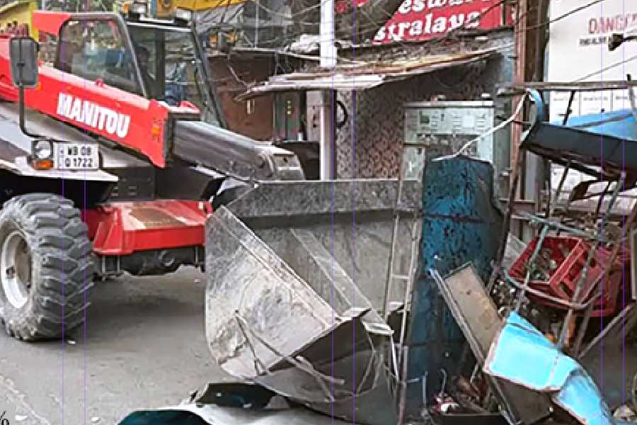 A bulldozer demolishes hawkers' stalls in Gariahat on Wednesday.