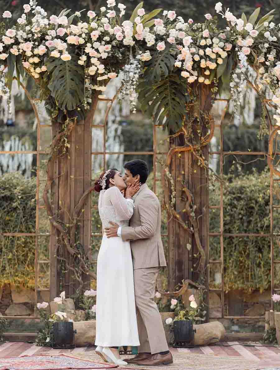 Ira and Nupur sealed their union with a kiss against a floral background.