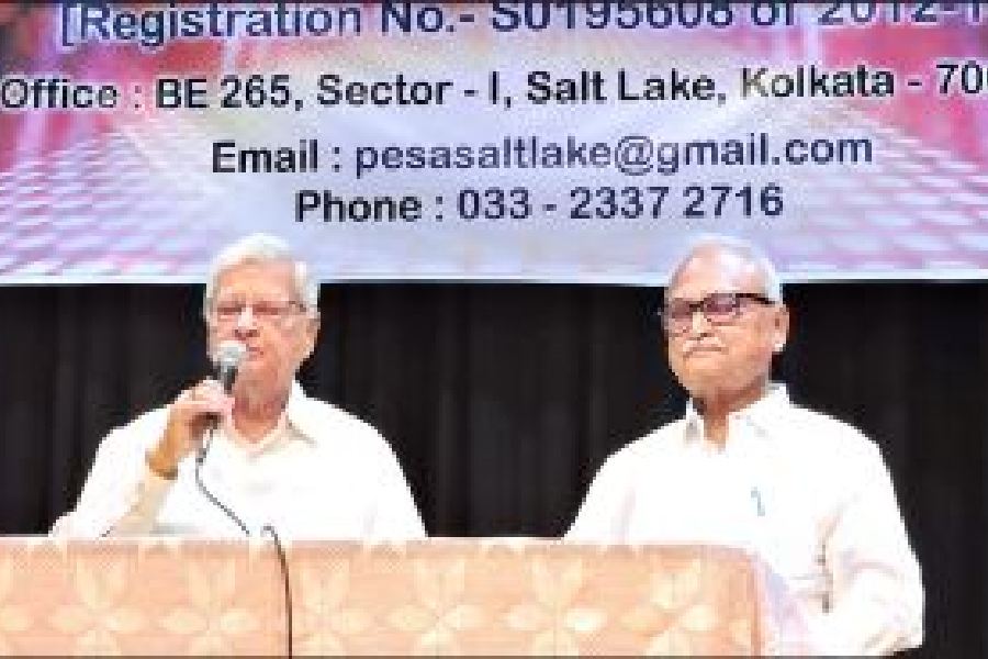 Justice (retd) Ganendra Narayan addresses the audience, with Pesa president Achyut Ghosh seated next to him