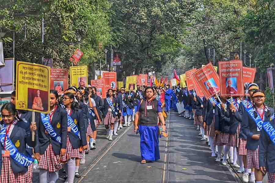 Schoolgirls hold placards with Swamiji’s sayings on Bidhan Sarani on Friday