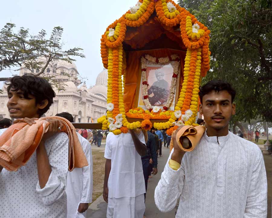 A garlanded photograph of Swami Vivekananda is carried on shoulders at Belur Math on Friday