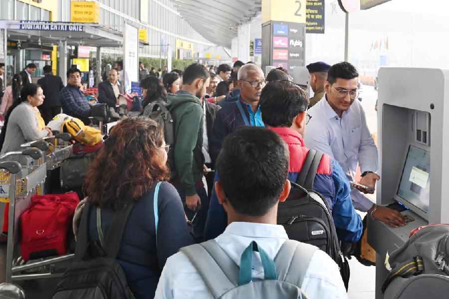 Passengers queue up at a DigiYatra registration kiosk outside the terminal of the airport on January 8.