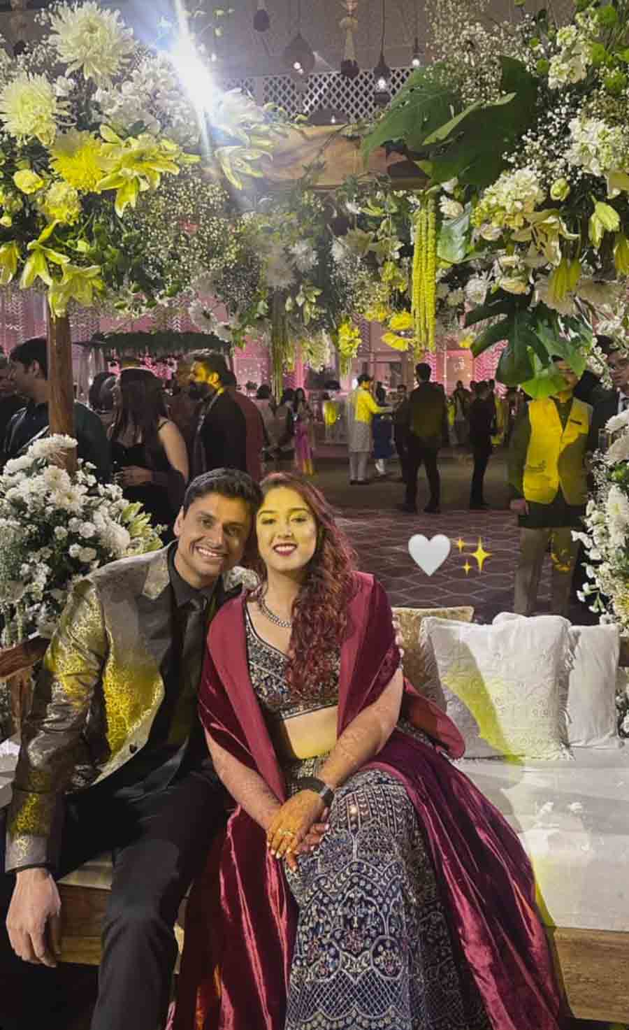 The newlyweds posed for a picture against a floral background at their Sangeet. While Ira slayed in a black-and-silver lehenga paired with a red cape, Nupur looked dapper in a black-and-golden suit. 