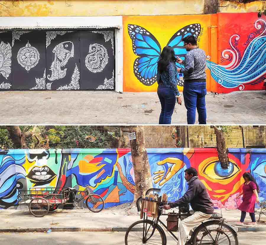 People stop by freshly painted graffiti at Gariahat area 