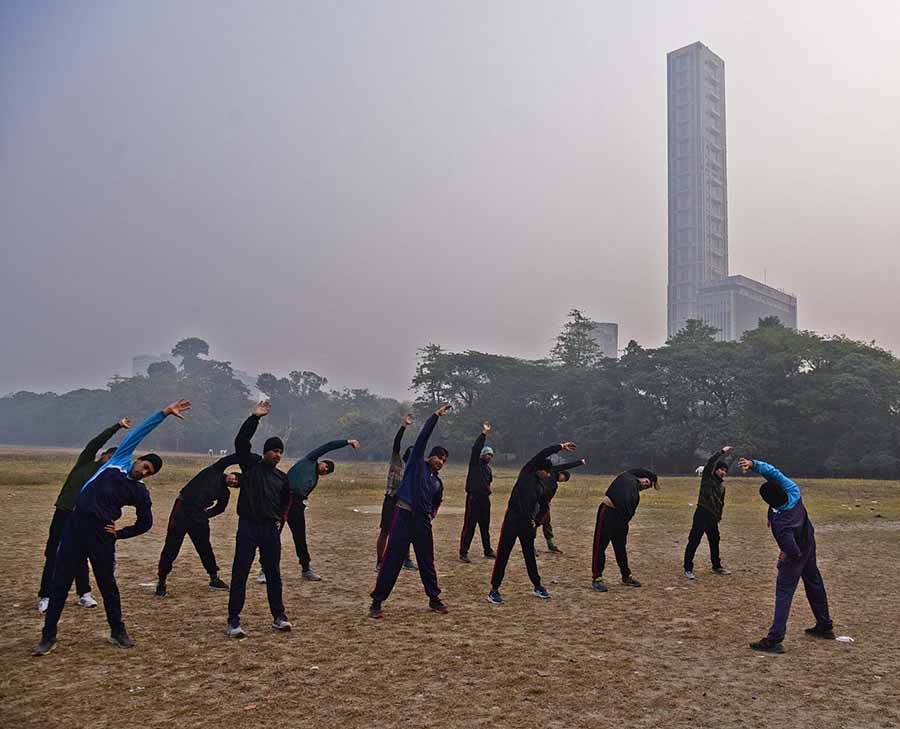 Kolkata Police personnel from the Police Training School during a physical training session amid heavy fog at Maidan on Wednesday. The lowest temperature recorded in the morning by IMD was 13°C 