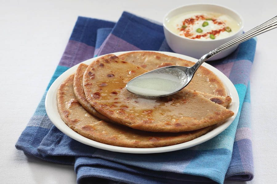 The aromatic morning parathas, ladened with clarified butter and pickles, were switched with gluten-free brown bread and low-fat cheese with some fruits!  
