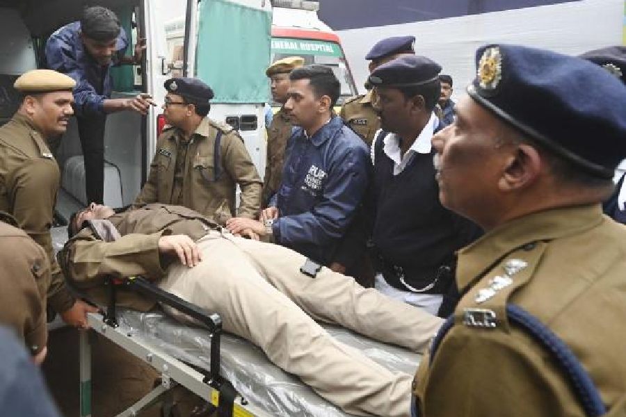 Additional police commissioner Murlidhar Sharma being taken to hospital after he got injured in the gate collapse