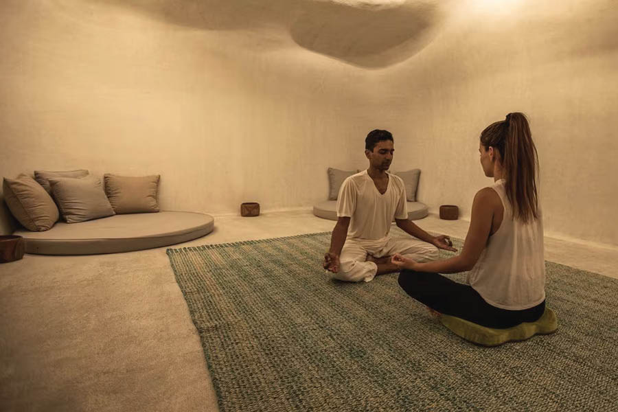 Cave meditation involves sitting on the cave floor with eyes closed and chanting Om