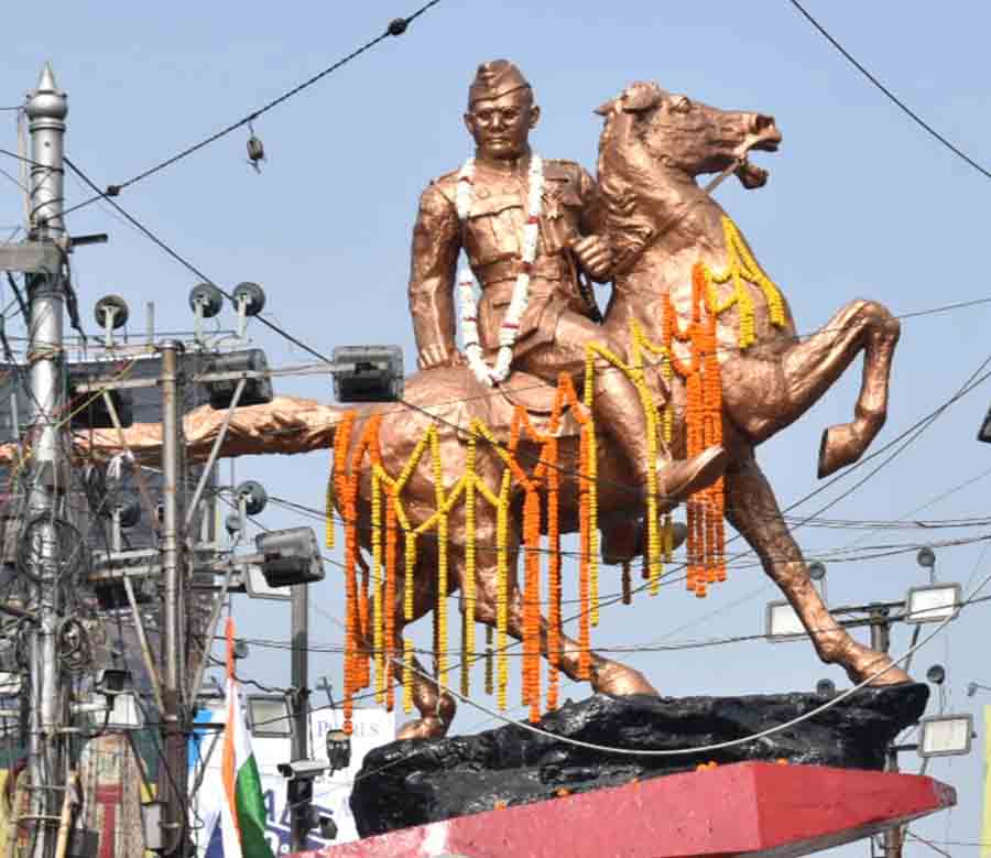 Marigold garlands adorn the galloping statue of Netaji Subhas Chandra Bose at the Shyambazar five-point crossing on his 127th birth anniversary on Tuesday
