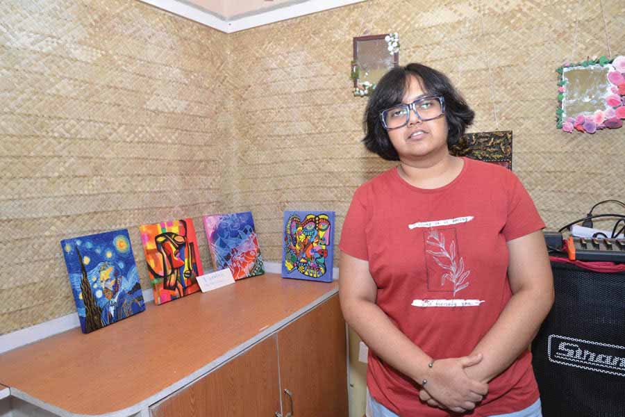Pooja Mukherjee with her paintings