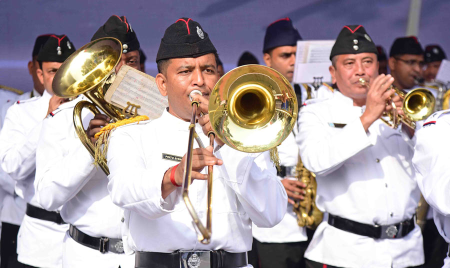 Members of the Kolkata police band blow their gleaming trumpets 