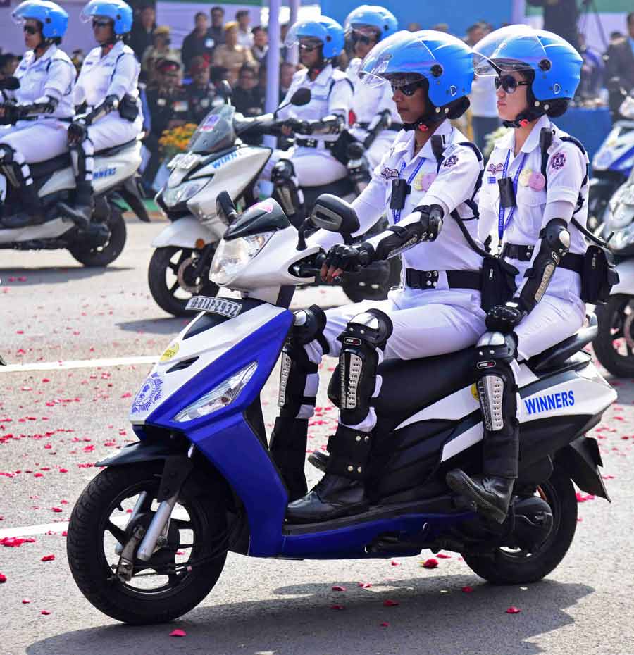 The Winners team from Kolkata Police ride past the podium on two-wheelers
