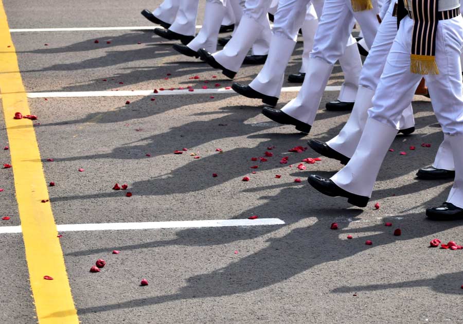Defence personnel clad in distinctive white livery and black gleaming boots march in perfect synchronisation on the rose-petal-strewn Red Road on Friday