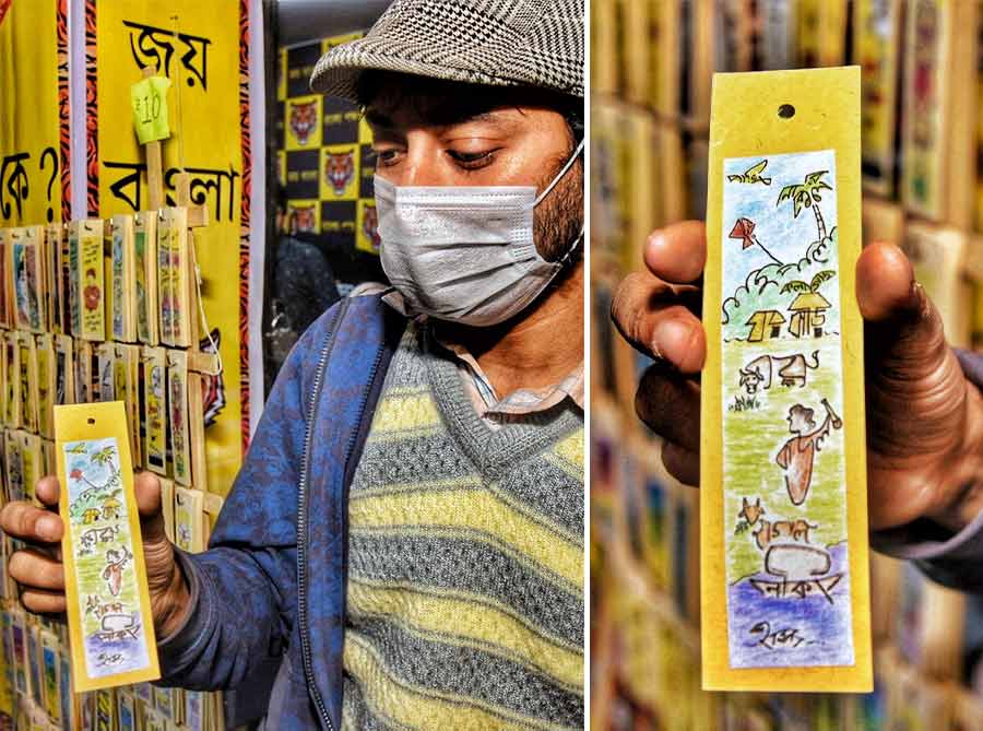 Chitragupta Sumon, a cartoonist, selling hand-drawn bookmarks at the International Kolkata Book Fair  