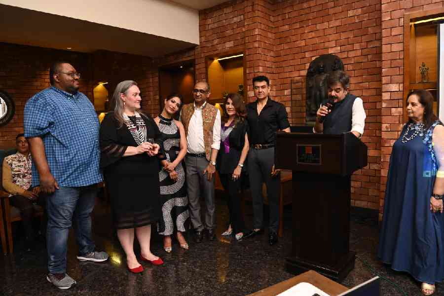 Host Rajinder Singh addresses the gathering as Melinda Pavek and others listen