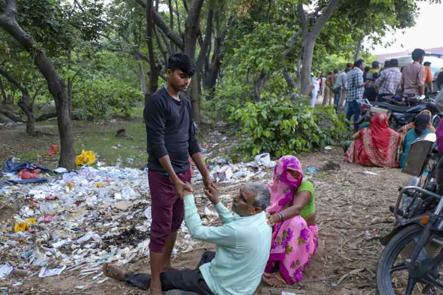 Relatives mourn the victims of the stampede in Hathras on Tuesday.
