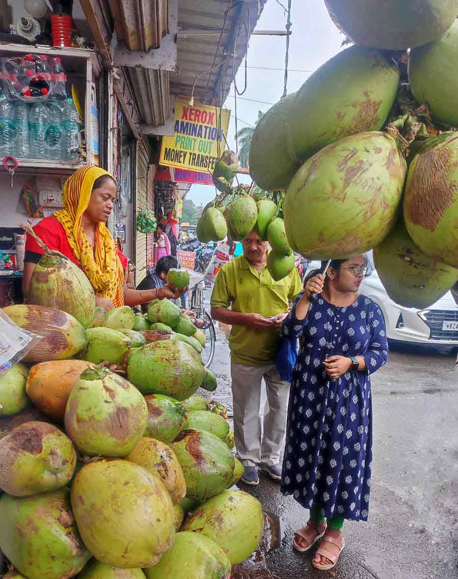 A woman sells coconut at Anandpur on the city’s southern fringes. Demand for coconut water has been steady despite the arrival of monsoon  