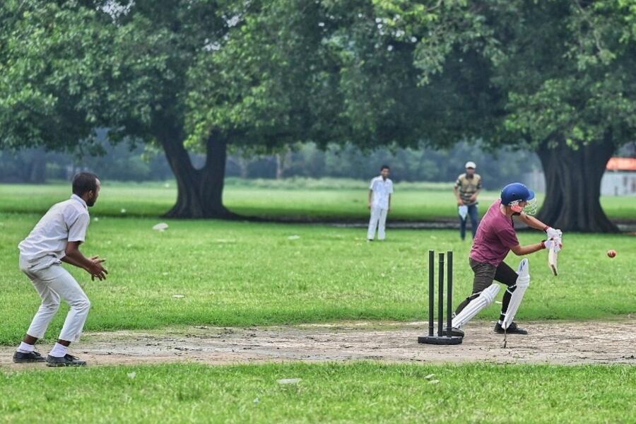 School students play cricket at the Maidan on an overcast Thursday afternoon  