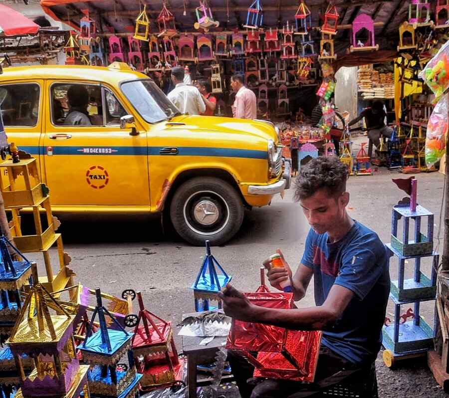 A youth lends finishing touches to raths at Lake Market on Friday afternoon two days ahead of Rath Yatra  