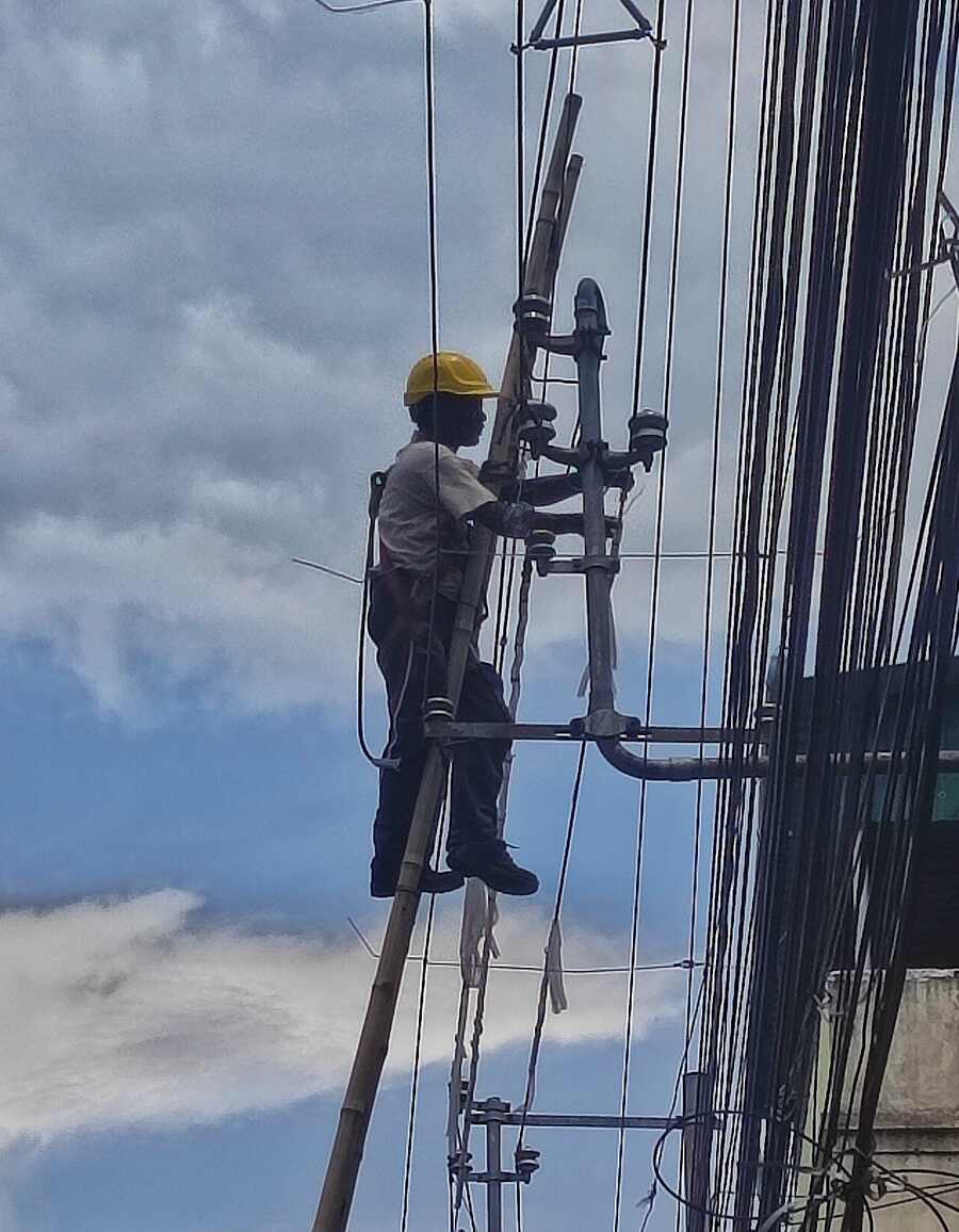 A worker maintains high tension power lines in north Kolkata