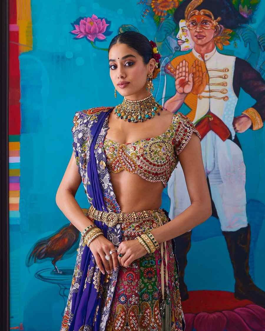 Smoky eyes, a coral lip shade and a plain black bindi were all Janhvi needed to turn heads ahead of the release of her political thriller Ulajh. A sleek braided bun adorned with a multi-coloured gajra balanced her look for the day.