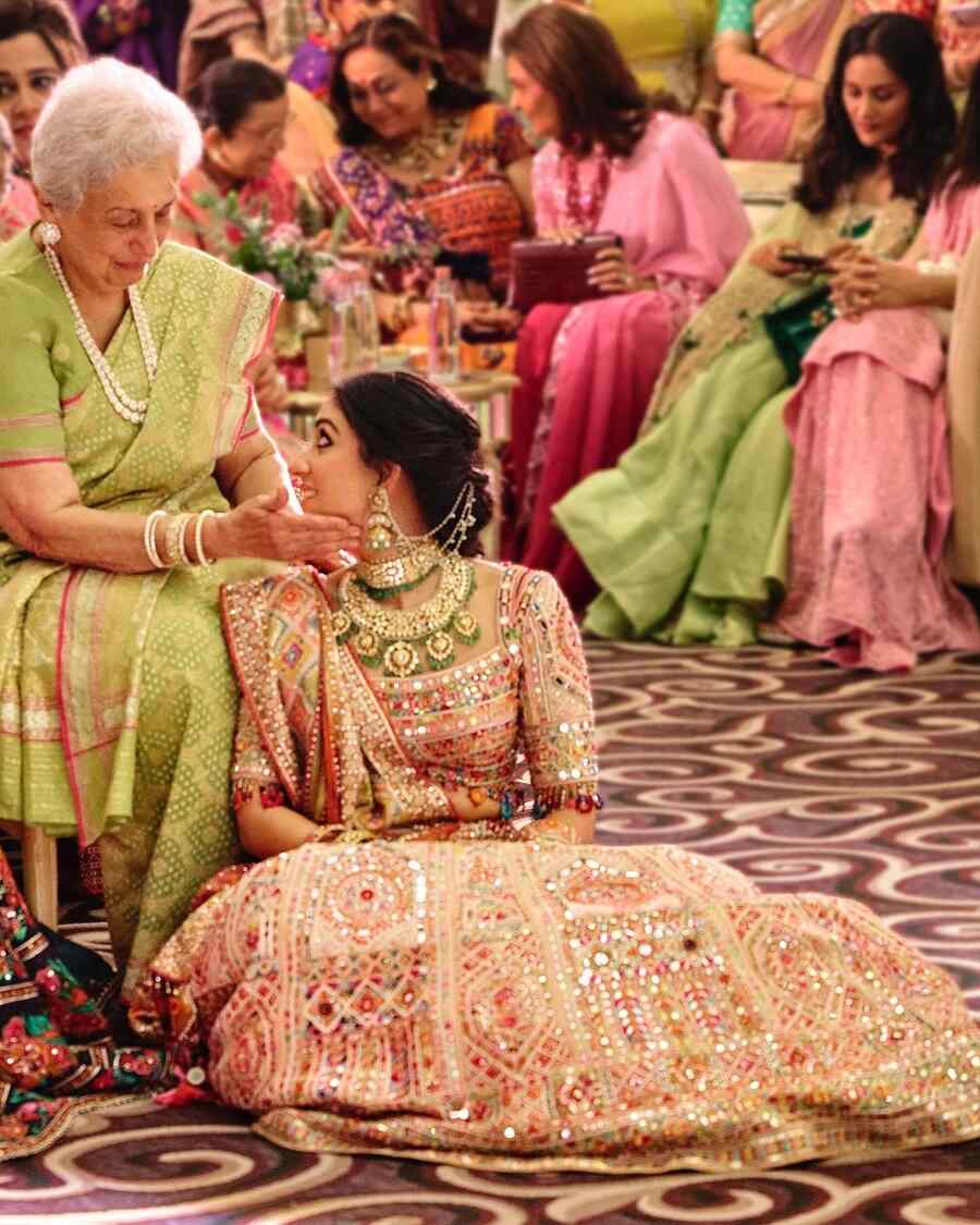 An elderly family member offered her blessings to Radhika, who fondly gazed at her.