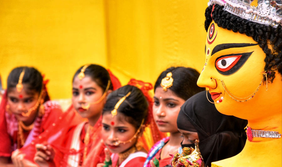 Young girls dress up in finery to take part in ‘Dharma Jar Jar, Utsab Sober’, an all-religion programme, in the run-up to Durga Puja at Gouriberiya Sarbojanin Durgatsab & Pradarshani in Maniktala on Wednesday