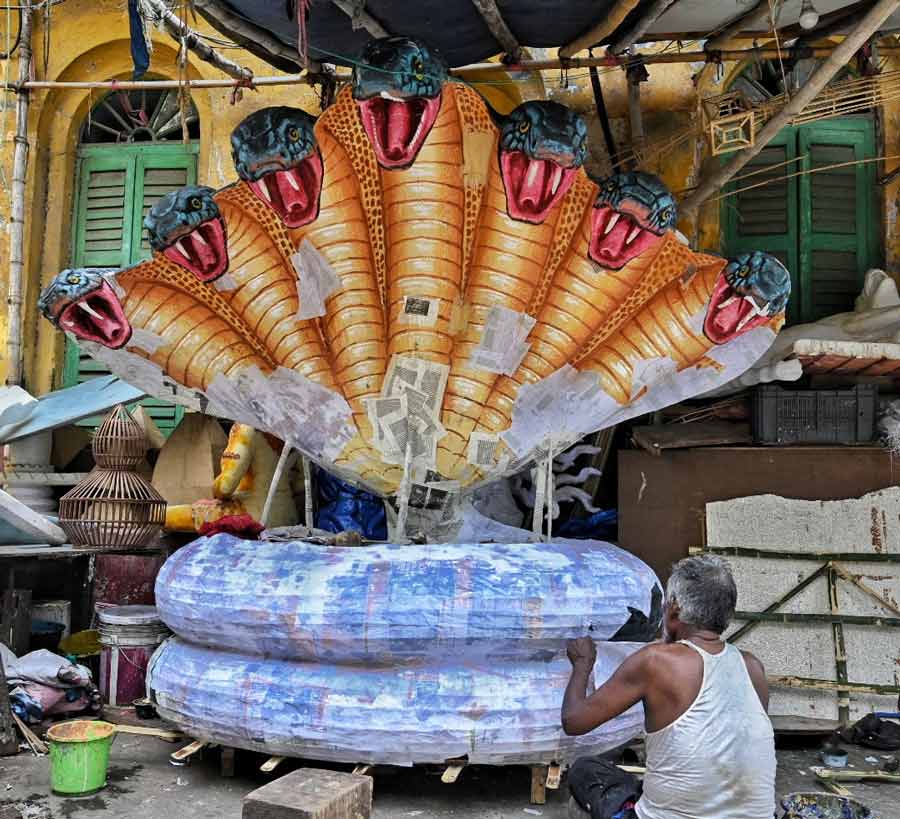 An artist makes props at Dompara off Chittaranjan Avenue on Thursday for Shravani Mela 