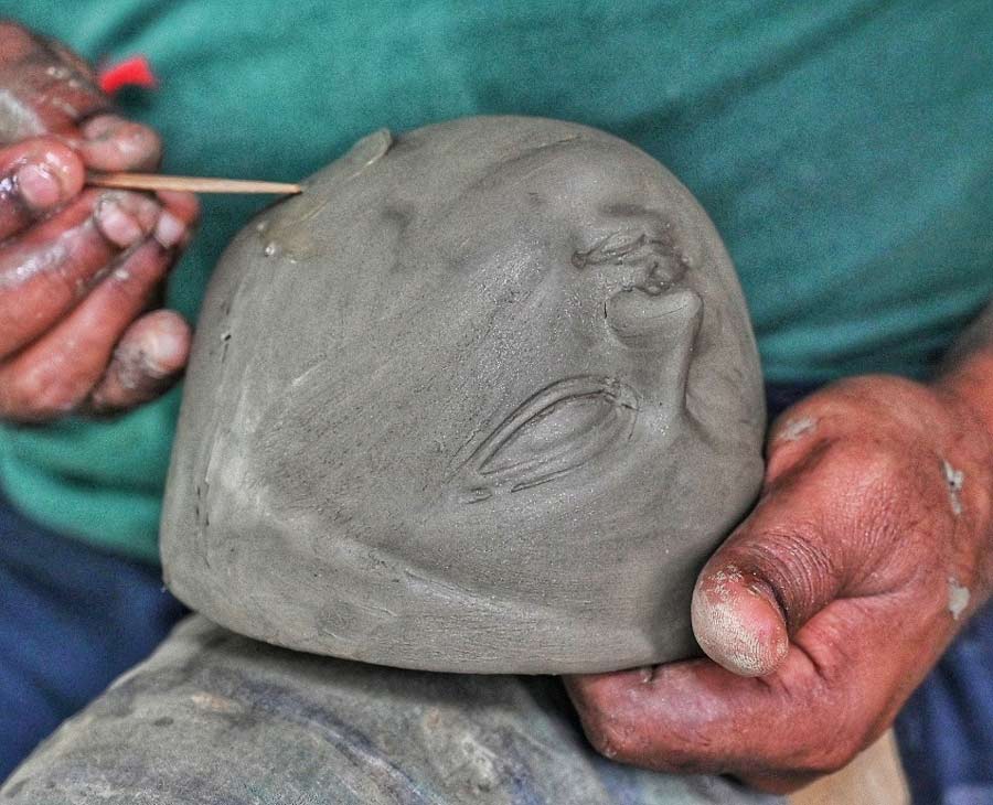 An artist works on a Durga idol face at Kumartuli on Monday. It's only 72 days to Mahalaya   