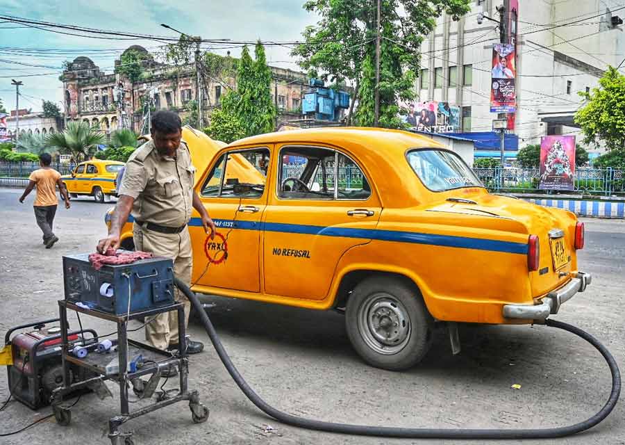A traffic policeman checks the emission level of a taxi at Esplanade on Tuesday