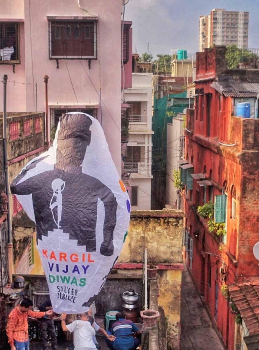 To mark the silver anniversary of Kargil Vijay Diwas, residents release a sky lantern from a house in north Kolkata