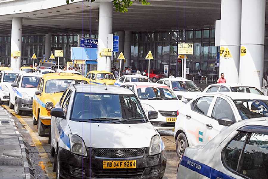 Parked yellow taxis and other commercial vehicles block most of the three lanes outside the airport terminal, meant for easy exit of app cabs and taxis, on Friday afternoon.
