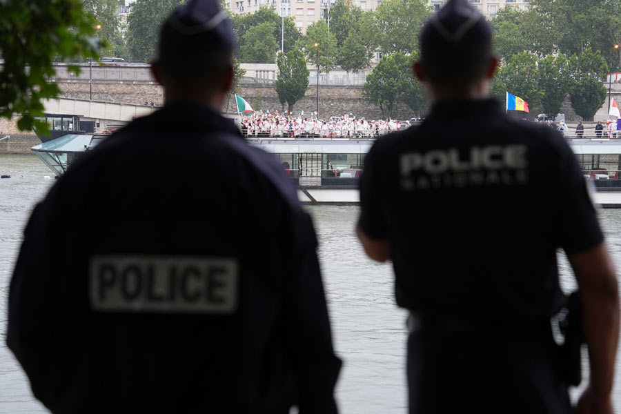 Police officers patrolled the streets during the opening ceremony of the 2024 Paris Summer Olympics along the Seine in Paris, on Friday, July 26, 2024. 