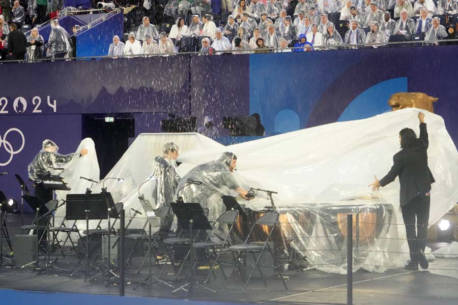 Instruments are covered up as rain falls at the Trocadero during the opening ceremony of the 2024 Paris Summer Olympics along the Seine in Paris, on Friday, July 26, 2024. 