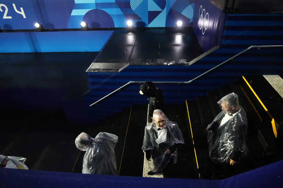 Attendees in ponchos during the opening ceremony of the 2024 Paris Summer Olympics along the Seine in Paris, on Friday, July 26, 2024. 