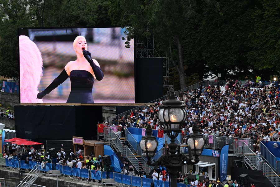 A video screen displays Lady Gaga performing during the opening ceremony of the 2024 Paris Summer Olympics along the Seine in Paris, on Friday, July 26, 2024. The Paris Games began with a new look and sparkled with Celine Dion, but the show suffered from bloat similar to TV’s other spectacles, writes the New York Times critic Mike Hale. 