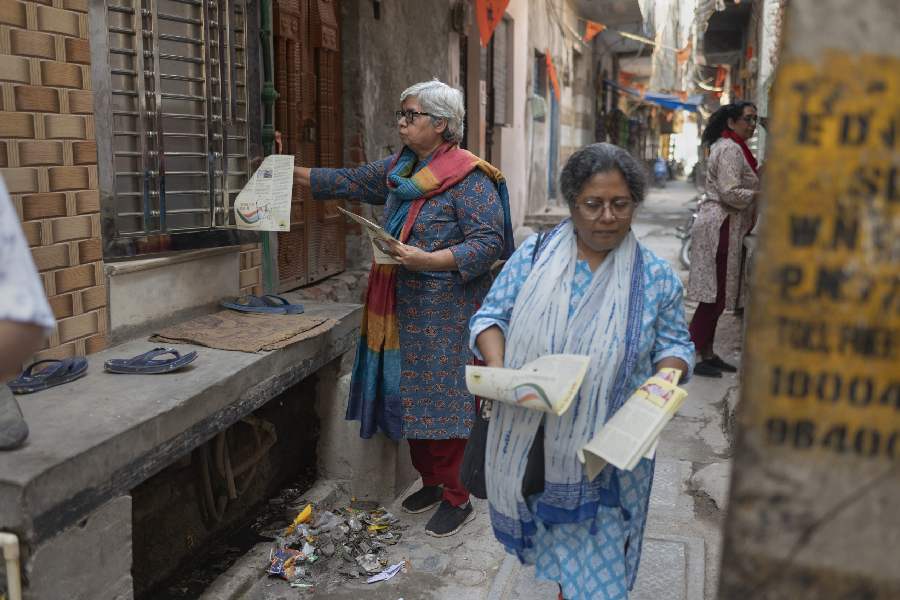 Shabnam Hashmi, left, a 66-year-old activist, and another woman hand out pamphlets with a message of peace and tolerance in New Delhi, May 9, 2024. Hashmi said she had been threatened with prison for her activism over the decades, but that it was “never so bad” as it is now.