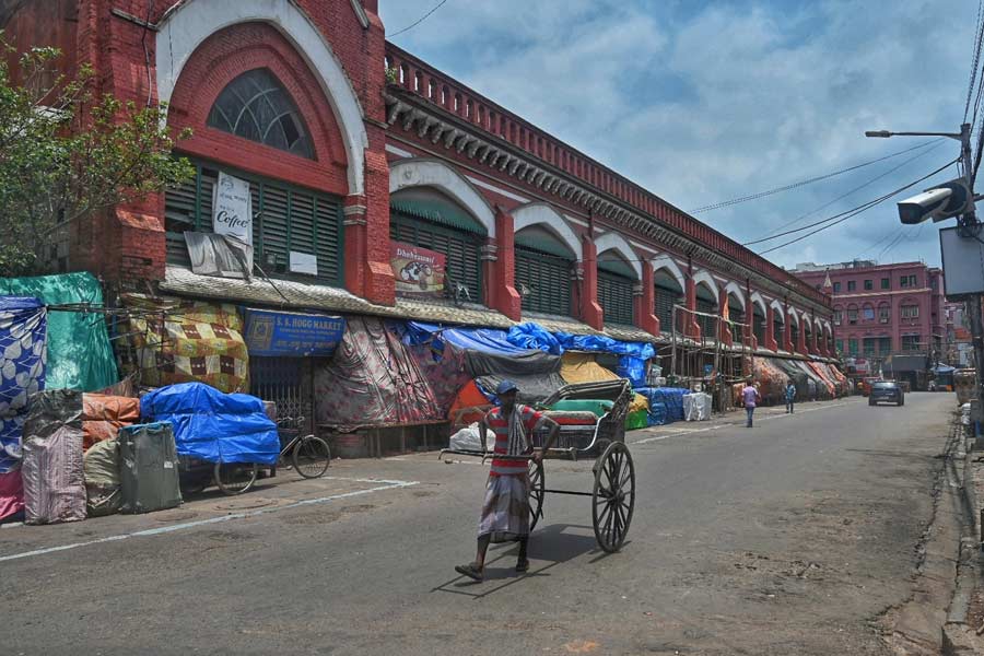 A lone rickshawpuller walks past Lindsay Street looking out for passengers