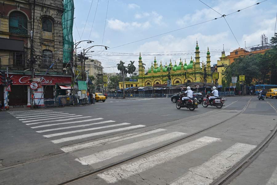 A couple of police sergeants ride past the Tipu Sultan mosque - KC Das crossing, which on any other day remains chock-a-block with traffic