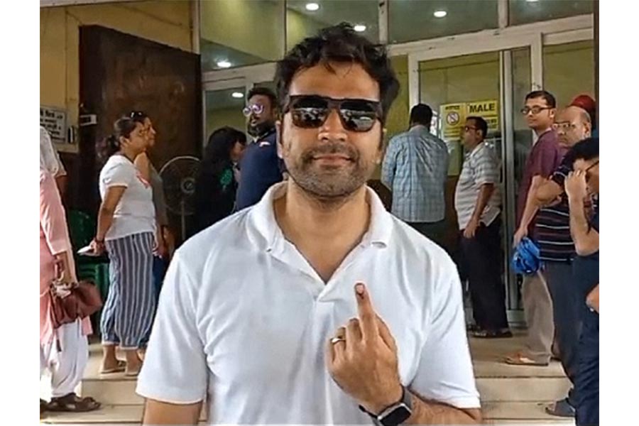 Sunglasses in place, actor Abir Chatterjee flashed his inked finger outside a voting centre in Salt Lake