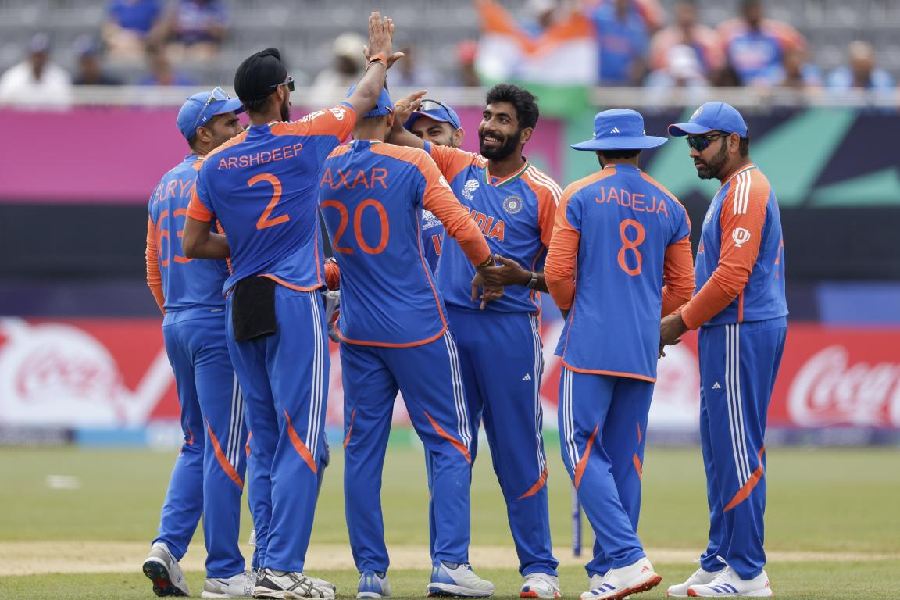 India's Jasprit Bumrah, third from right, is congratulated by teammates after taking the wicket of Ireland's Harry Tector during an ICC Men's T20 World Cup cricket match at the Nassau County International Cricket Stadium in Westbury