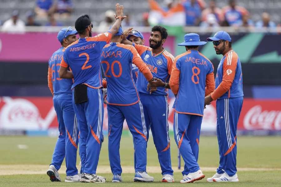 Jasprit Bumrah (centre) with teammates after the first of his two wickets against Ireland in New York on Wednesday. (AP/PTI)