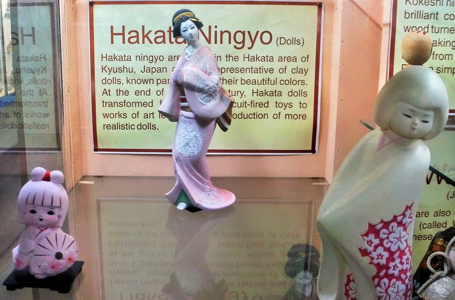 The Hakata Ningyo dolls (centre and right) represent the traditional craftsmanship of the city of Fukuoka in the Kyushu region of Japan. A distinct feature of these clay dolls is the finely detailed face with serene expressions, painted by hand, making these treasured items and collectibles, especially in Japan