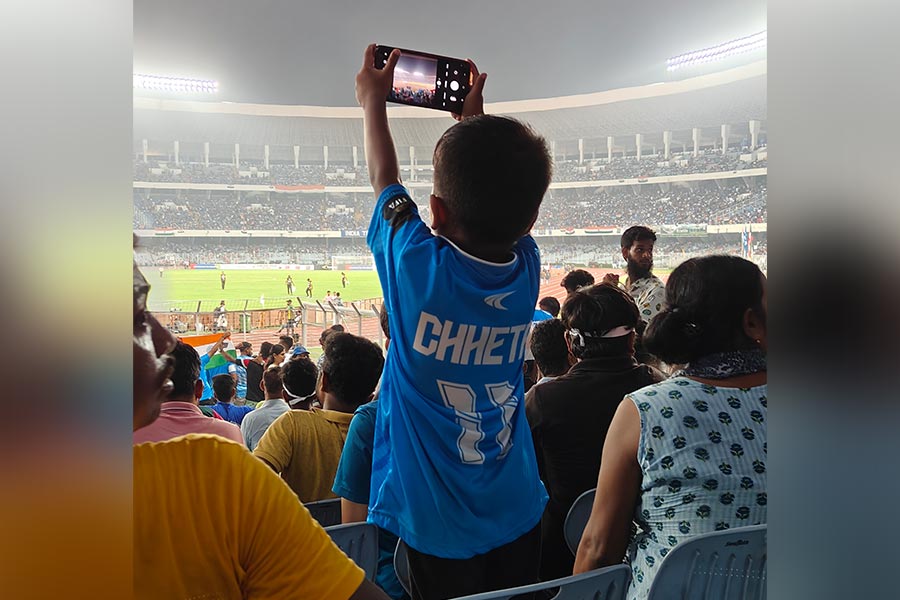 A young fan captures the action