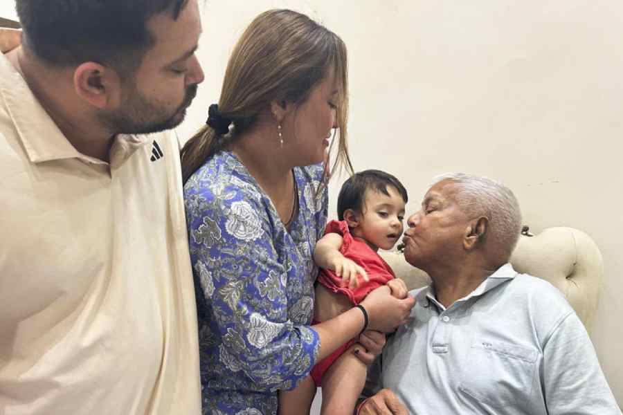 Lalu Prasad with his son Tejashwi Yadav and grandchild during his birthday celebrations in Patna