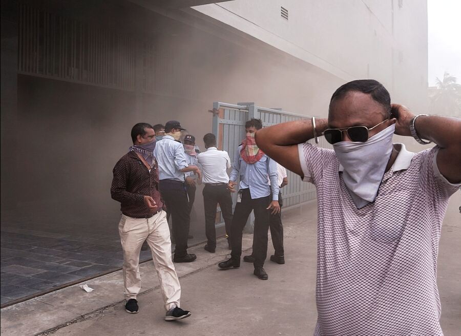 Mall and office employees rush out wearing handkerchiefs around their nose and mouth